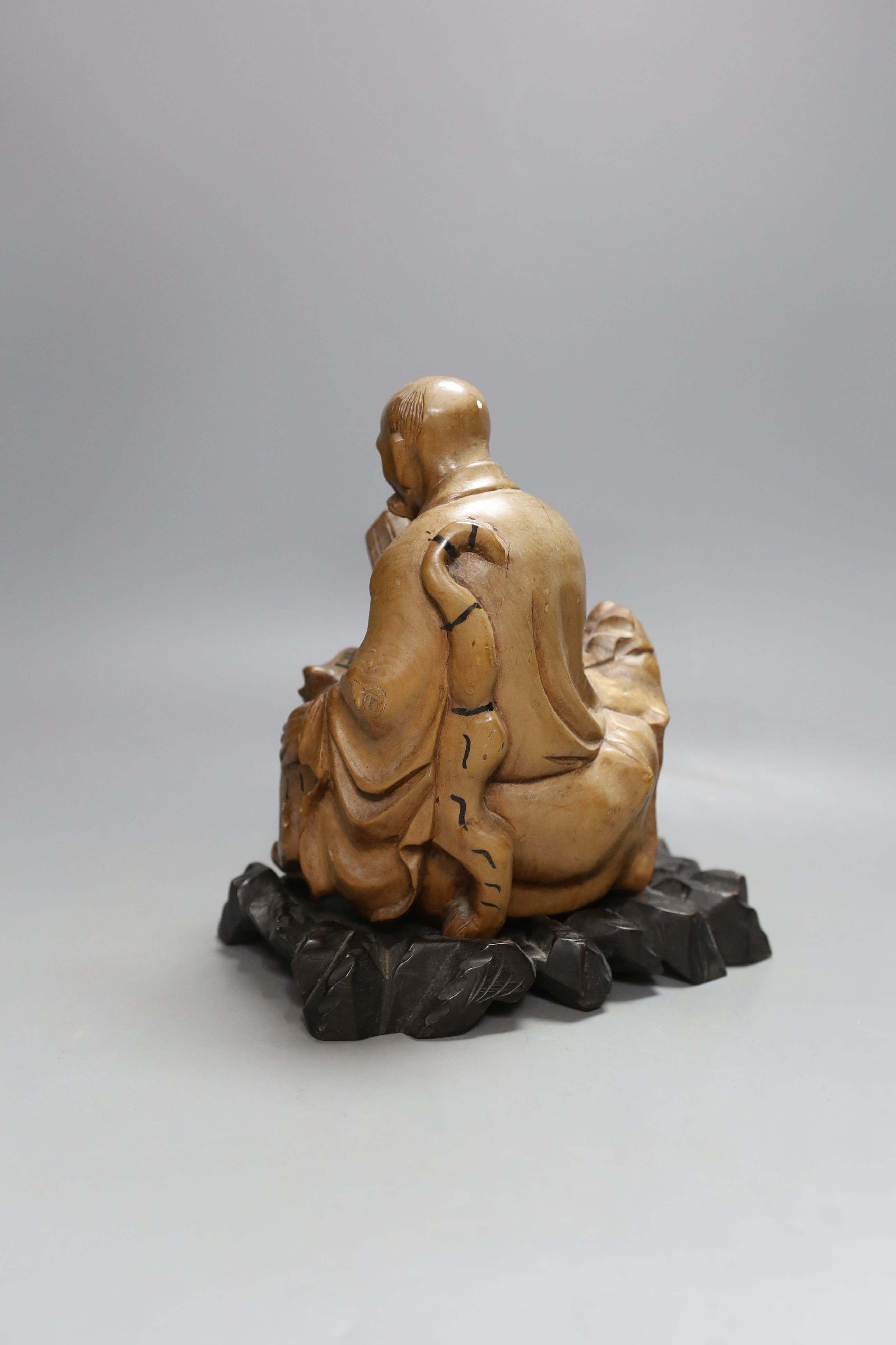 A Chinese wood group of a luohan - 21cm tall